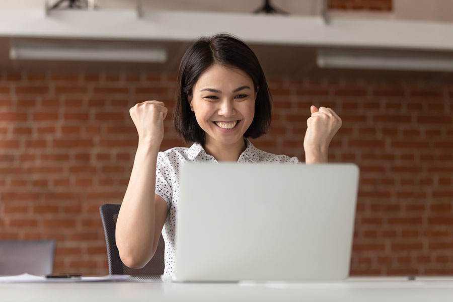 woman-cheering-laptop woman-cheering-laptop